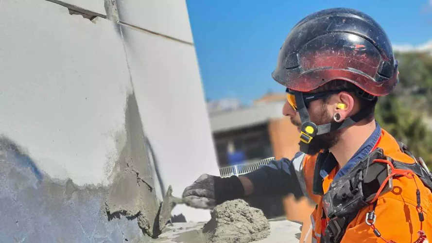 worker repairing the high rise building